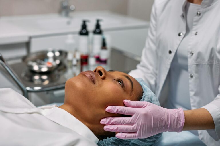 An expert administering a facial treatment to a woman in a modern skincare clinic.